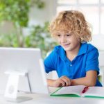 back to school boy on computer web banner