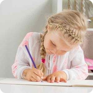 Girl drawing on a free printable of Montessori resource